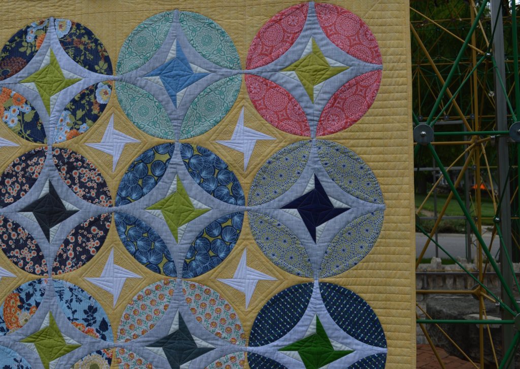 Eclipse quilt by Sharon McConnell, curved piecing orange peel quit design with stars