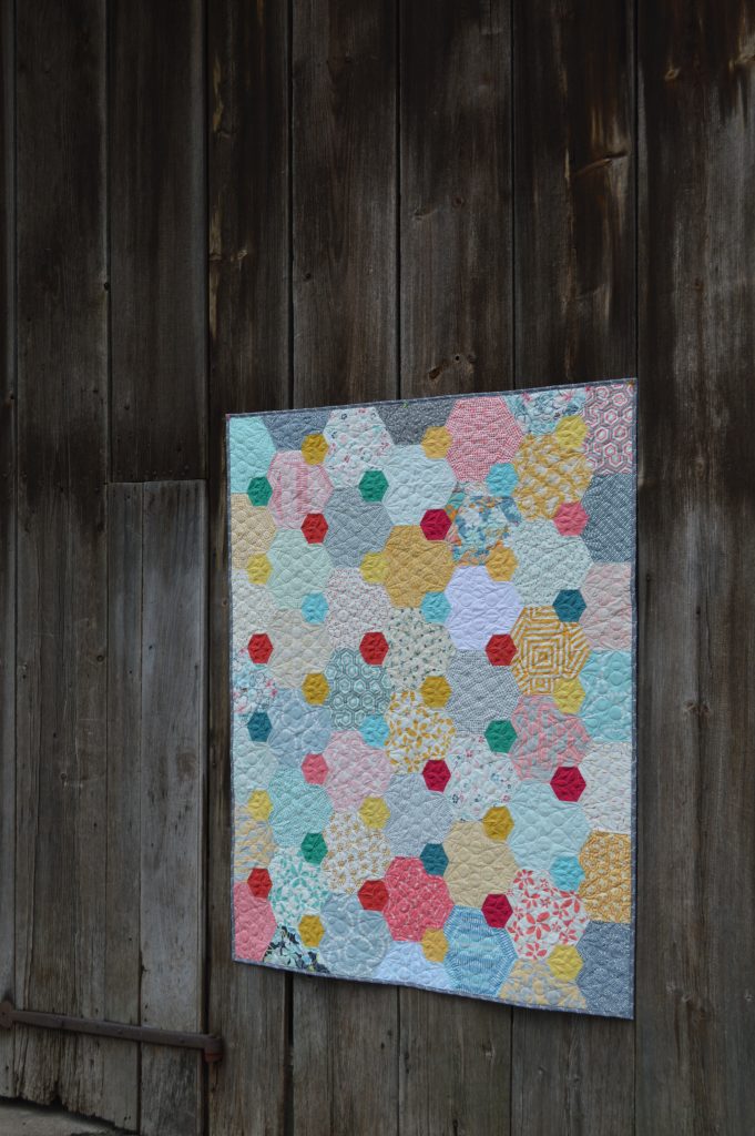 Pops hexagon patchwork quilt by Sharon McConnell, featured in Quilt Now Magazine