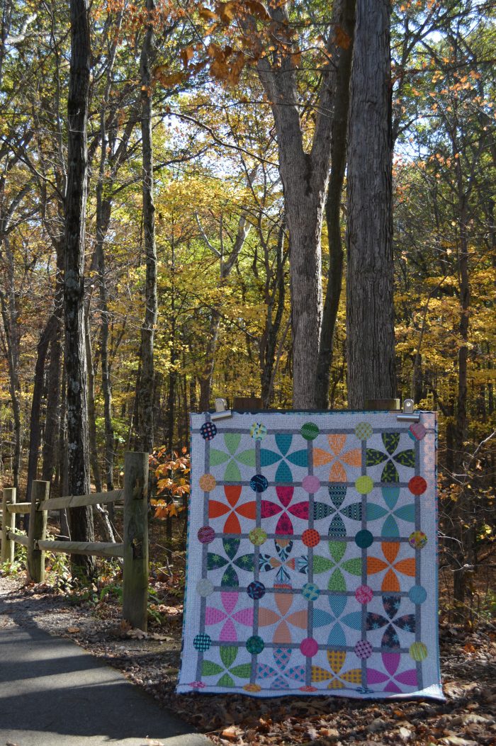 Whimsy Garden quilt by Sharon McConnell, modern scrappy patchwork with curved piecing and appliqué
