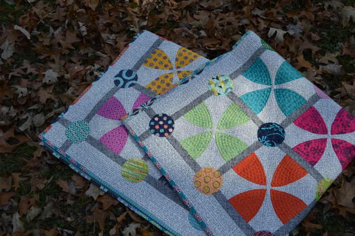 Whimsy Garden quilt by Sharon McConnell, modern scrappy patchwork with curved piecing and appliqué 