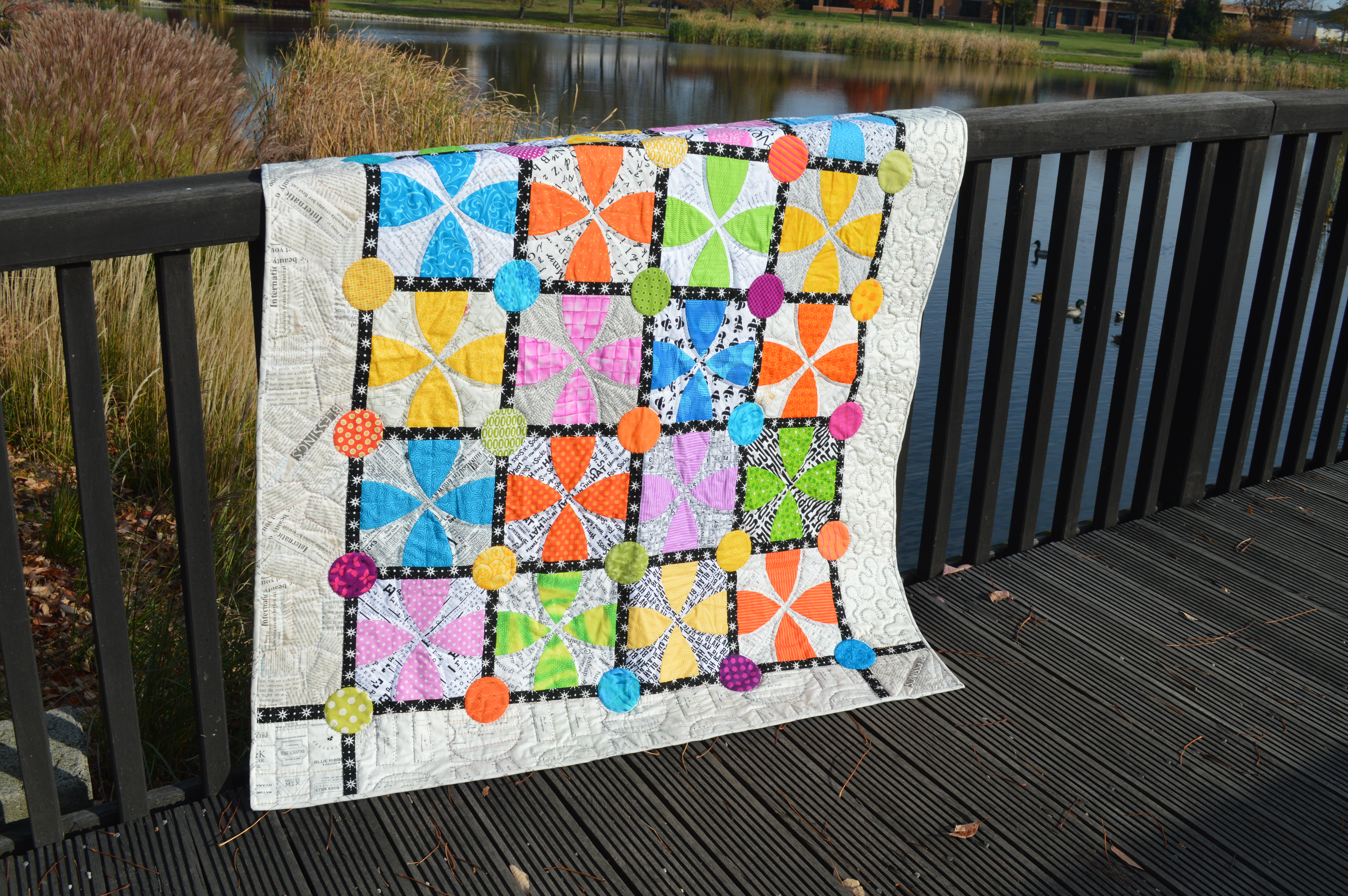 Whimsy Garden quilt pattern by Sharon McConnell Color Girl Quilts with bright colors, low volume fabrics, curved piecing