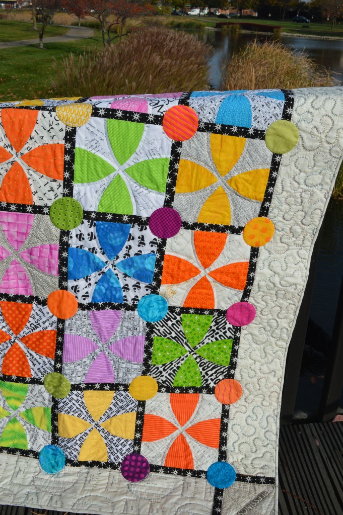 Whimsy Garden quilt pattern by Sharon McConnell Color Girl Quilts with bright colors, low volume fabrics, curved piecing