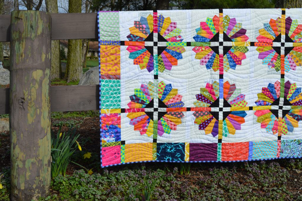 Daisy quilt pattern by Sharon McConnell, modern dresden scrappy bright quilt