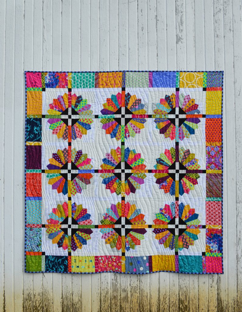Daisy quilt pattern by Sharon McConnell, modern dresden scrappy bright quilt