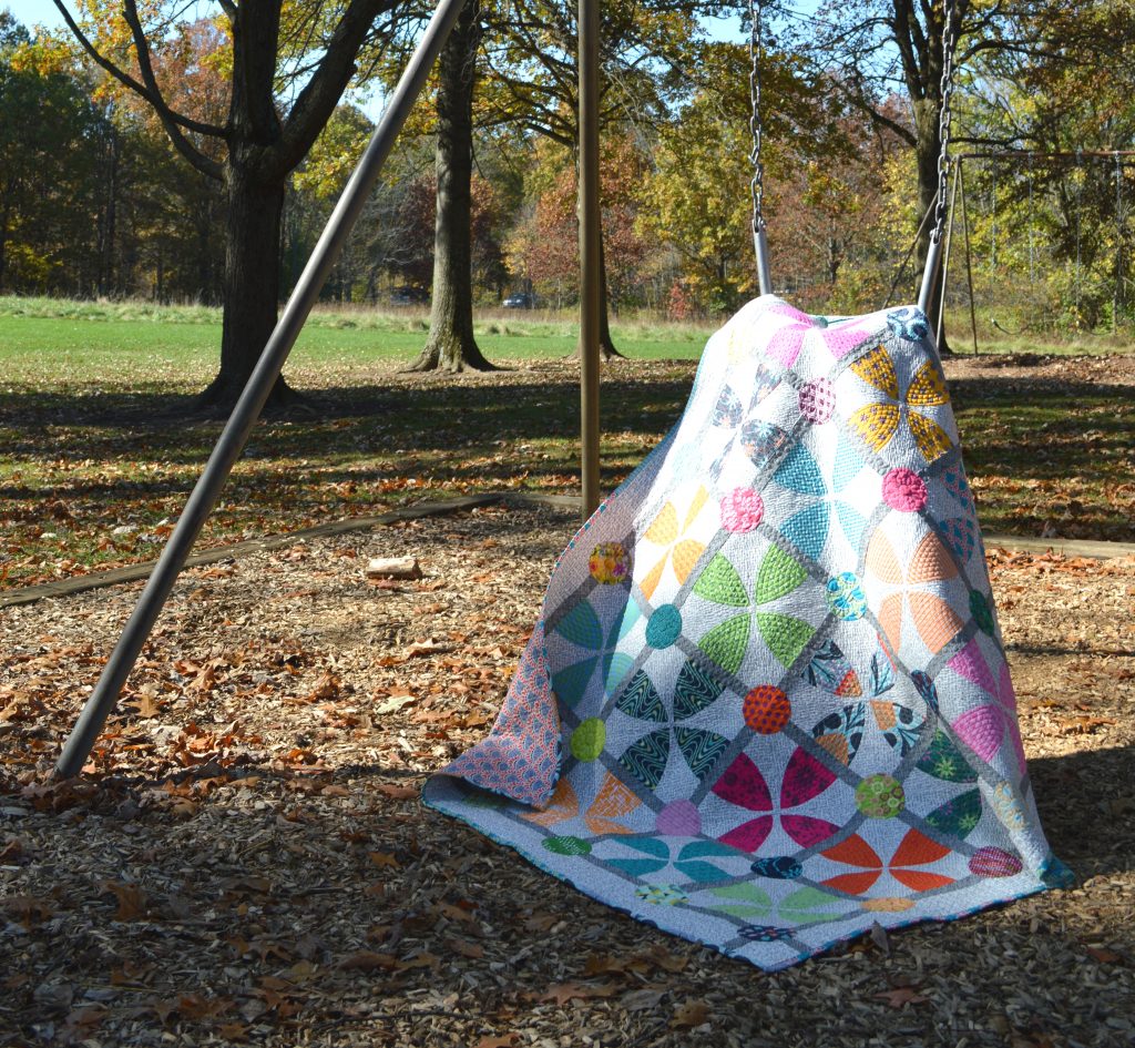 Whimsy Garden quilt pattern cover by Sharon McConnell, Color Girl Quilts. Modern Curved piecing with the Classic curves Ruler