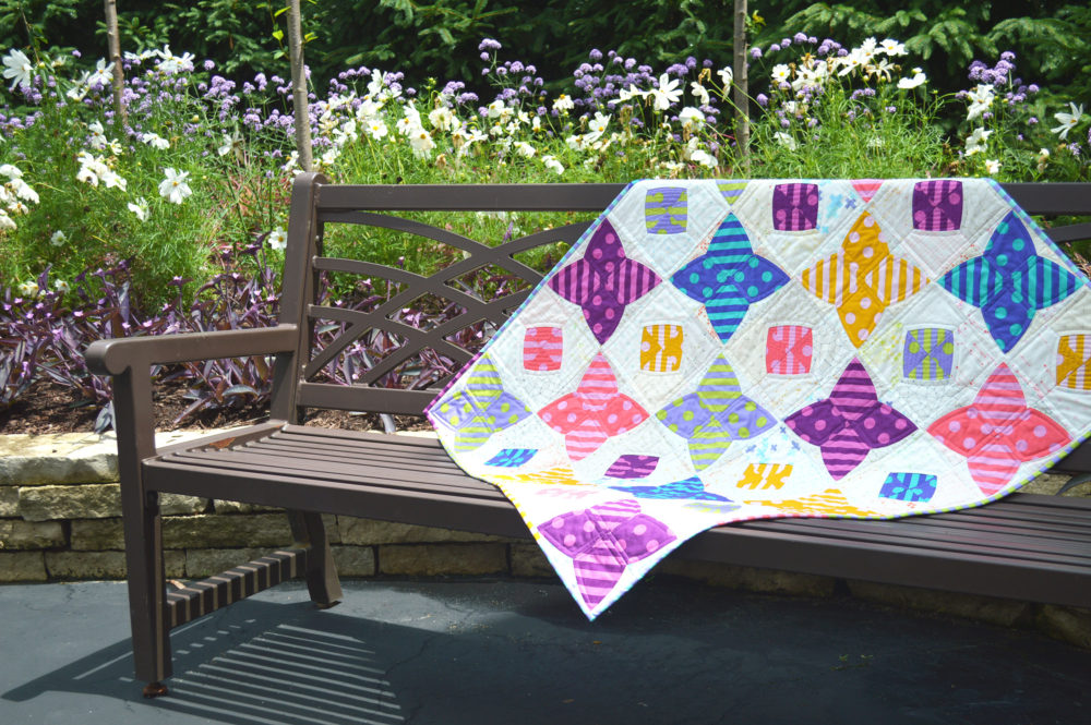 PomPom quilt by Sharon McConnell, Color Girl Quilts with the Classic curves Ruler and Tula pink fabrics